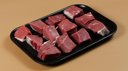 Raw meat on black tray