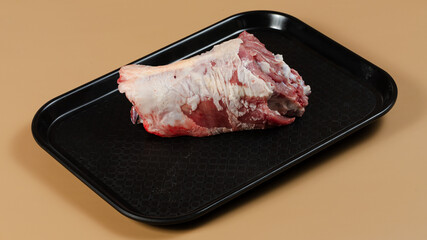 Raw meat on black tray