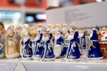 Decorative Santa figurines in blue attire for holiday celebrations.