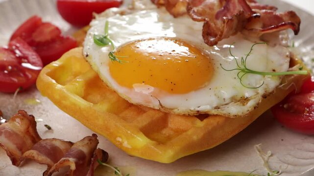 close up of sunny sidet egg and bacon waffles zoom