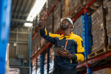 African American man worker wearing uniform and helmet safety with tablet working and checking...