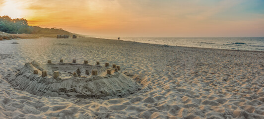 Sandburg in filigraner Detailarbeit vor der Seebrücke Zinnowitz (Usedom) im warmen Licht der...