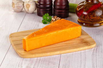 Yellow cheddae cheese over board