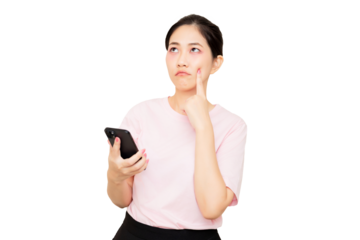 A woman in a pink shirt holds a smartphone, while pondering, with her finger resting on her cheek