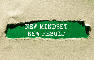 New mindset new result message written on ripped torn paper on green background. Conceptual new...