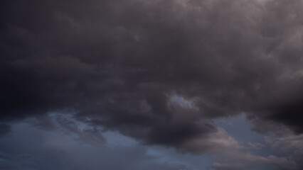 Fototapeta premium Overcast sky with dark clouds. Dark sky before a thunder-storm. The gray cloud background before rain.
