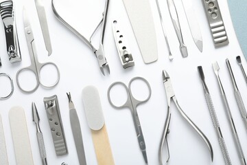 Set of different manicure tools on white background, flat lay