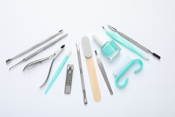 Set of different manicure tools on white background, flat lay