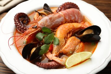 Delicious seafood soup in bowl on table, closeup