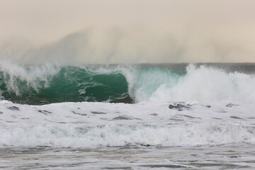 Big wave with splashes on the ocean coast