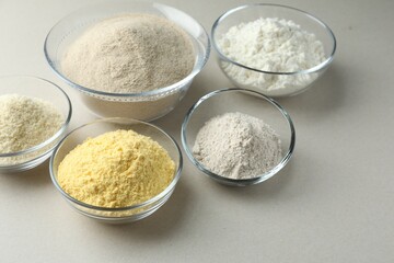 Different types of flour on white background, closeup