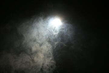 Beautiful smoke in lights on dark background