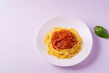 Photo of fettuccine with tomato-textured sauce on a white plate, top view.