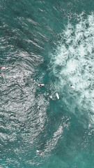 Aerial shot of surfers catching waves along Sri Lanka’s tropical coast, popular destination for surf lovers