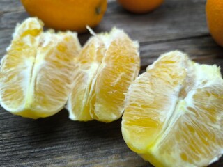 juicy ripe yellow oranges lie on a wooden table