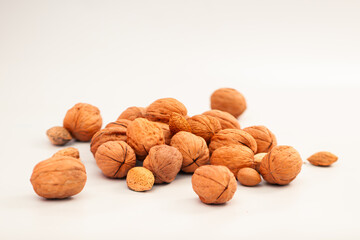 Assorted Nuts on White Background – Healthy Mix of Walnuts, Almonds, and Pecans (Isolated Top View).

