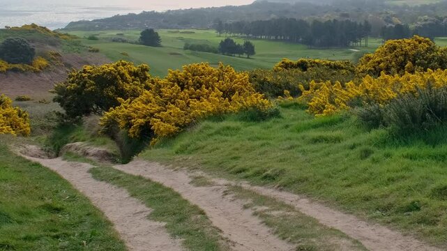 Walking the Paston Way along the clifftops in Cromer, Norfolk Coast. Left to right panning shot.