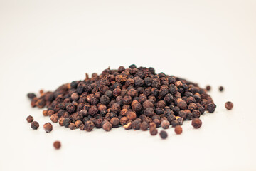 Whole Black Peppercorns Heap – Rustic Spice Texture on Clean White Backdrop