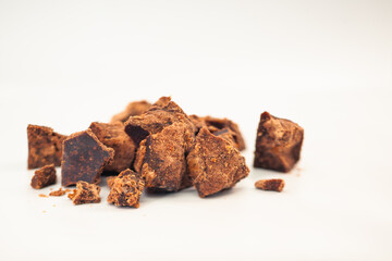 Crushed Panela Chunks – Golden Unrefined Sugar Pile on Minimalist White Surface