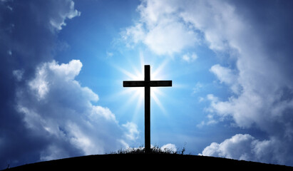The silhouette of the cross as a symbol of the Christian religion against the background of the sky. Concept on the theme of God, paradise, religion, Christian faith. Religious background.