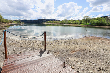 A lake drying up due to climate change. The bottom is being exposed as a result of the loss of...