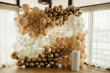 Birthday photo zone with shiny balloons and glowing lettering