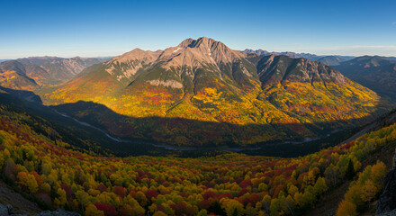 Vibrant Autumn Mountain Range with Colorful Forest Valley