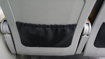 An appearance from behind a seat in an airplane
