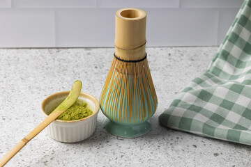 Matcha tea ceremony preparation with chasen whisk and bamboo spoon