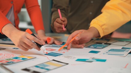 Collaborative brainstorming session with diverse individuals creating digital mockups and sketches...