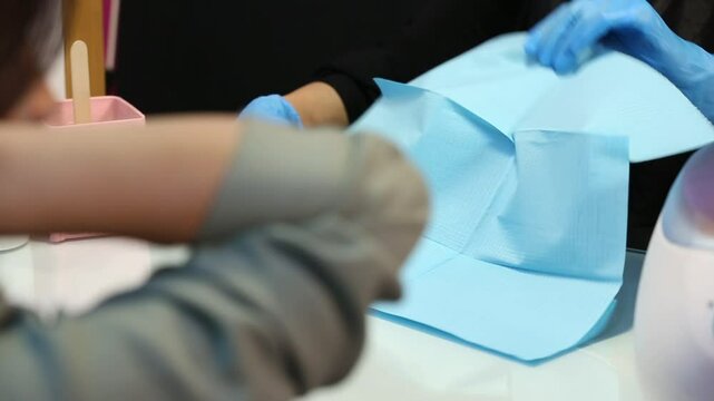 This clip shows a woman getting a paraffin wax treatment for her hands. Ideal for spa, beauty, and nail care content. Shows a warm, relaxing therapy.