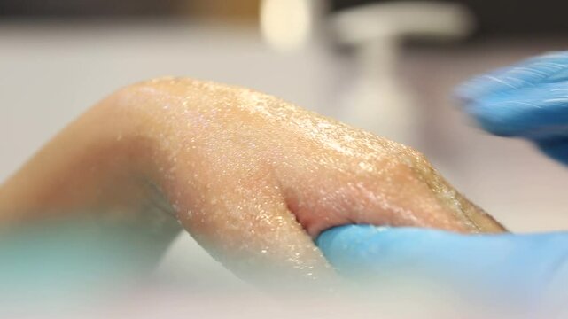 This clip shows a woman getting a paraffin wax treatment for her hands. Ideal for spa, beauty, and nail care content. Shows a warm, relaxing therapy.
