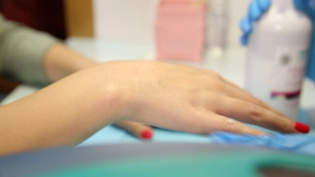 This clip shows a woman getting a paraffin wax treatment for her hands. Ideal for spa, beauty, and nail care content. Shows a warm, relaxing therapy.