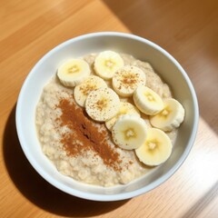 Creamy Oatmeal with Banana Slices and Cinnamon on Wooden Table – Healthy Breakfast"