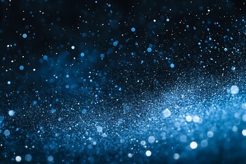 Fototapeta premium Abstract blue glittering particles resembling a galaxy against a dark background