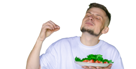Bearded man in a white t-shirt joyfully pretending to eat a fresh vegetable salad with tomatoes and lettuce, on a transparent background