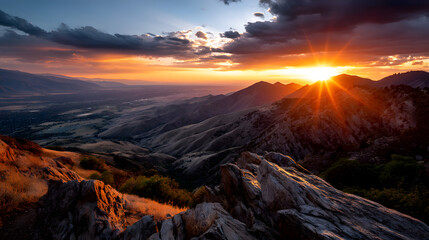 Fototapeta premium An intense orange sunset fills the sky as the mountains cast long, dramatic shadows over the valley below.