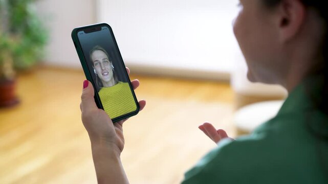 Young woman making a video call to a friend on smartphone.