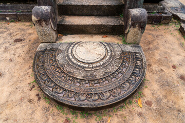 Moonstone of Kumara Pokuna, ancient royal bathing pool in the Ancient City of Polonnaruwa, Sri Lanka, showcasing ancient architecture.