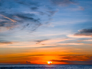 Colourful Sunset at Kamala Beach in Phuket Thailand. Kamala beach on Lovely island of phuket where the waters are turquoise blue, lush green mountains colourful skies