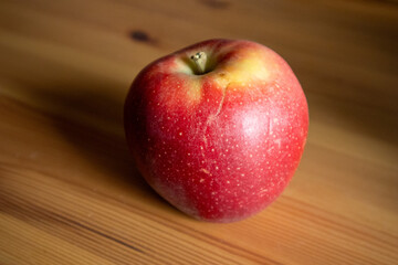 Healthy Red Apple on Rustic Wooden Table – Natural Light Nutrition Concept

