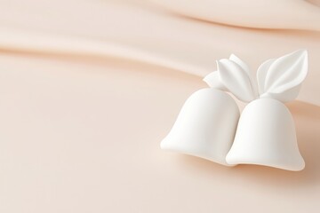 Elegant pair of white bells on soft peach background