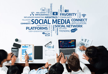 A team collaborates in a dynamic workspace focusing on social media strategy. They analyze data,...