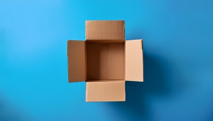 overhead view of open empty cardboard box on blue background