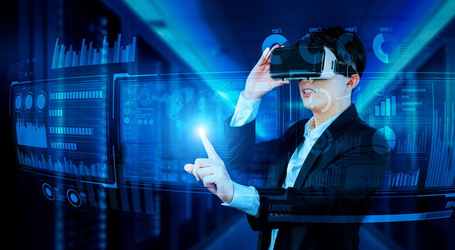 Businessman with headset standing at data center while analyzing financial data. Manager pointing marketing statistic hologram and using augmented reality goggles while making a decision. Ingenuity.