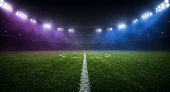 Fototapeta Empty soccer stadium field at night with bright stadium lights casting shadows for sports event and competition concept