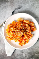 Striped macaroni with tomato sauce