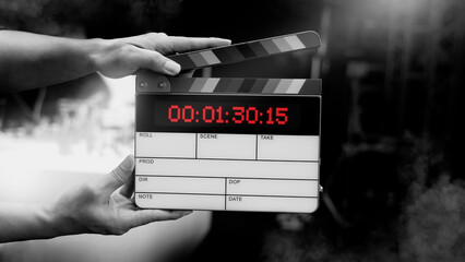 Digital film slate for filmmaker in set. Hand hitting timecode clapperboard or movie slate for...