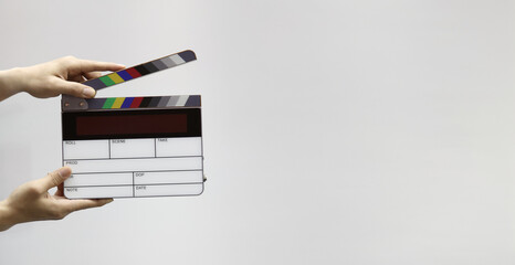 Digital film slate for filmmaker in set. Hand hitting timecode clapperboard or movie slate for...