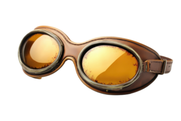 Vintage pilot goggles with amber lenses and leather strap, resting on dark background